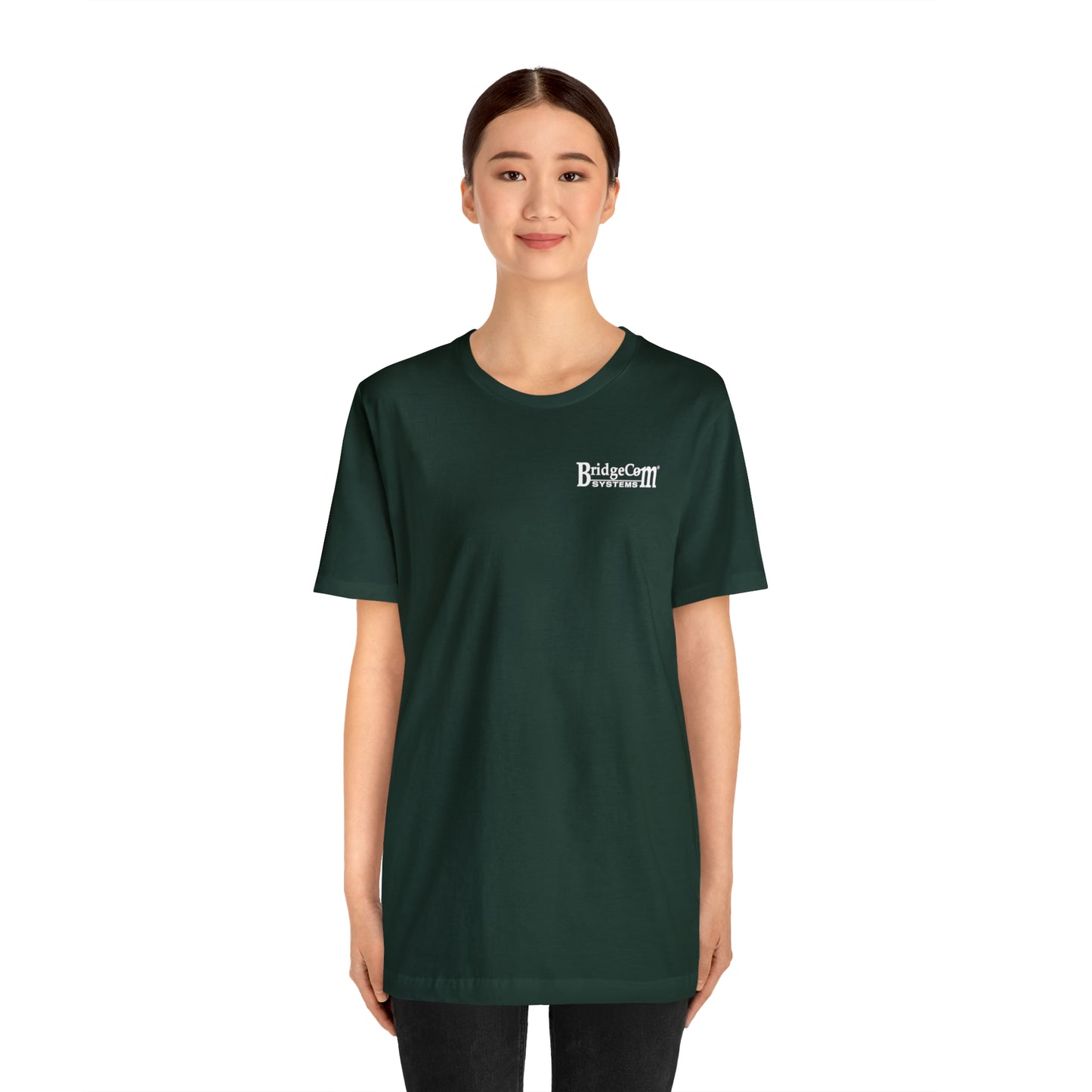 A person with tied-back hair is wearing a dark green Short Sleeve Tee - Small Logo made of Airlume combed cotton, with "Bridgestar Developers" printed in white text on the upper left side. The person is standing and smiling against a plain white background.