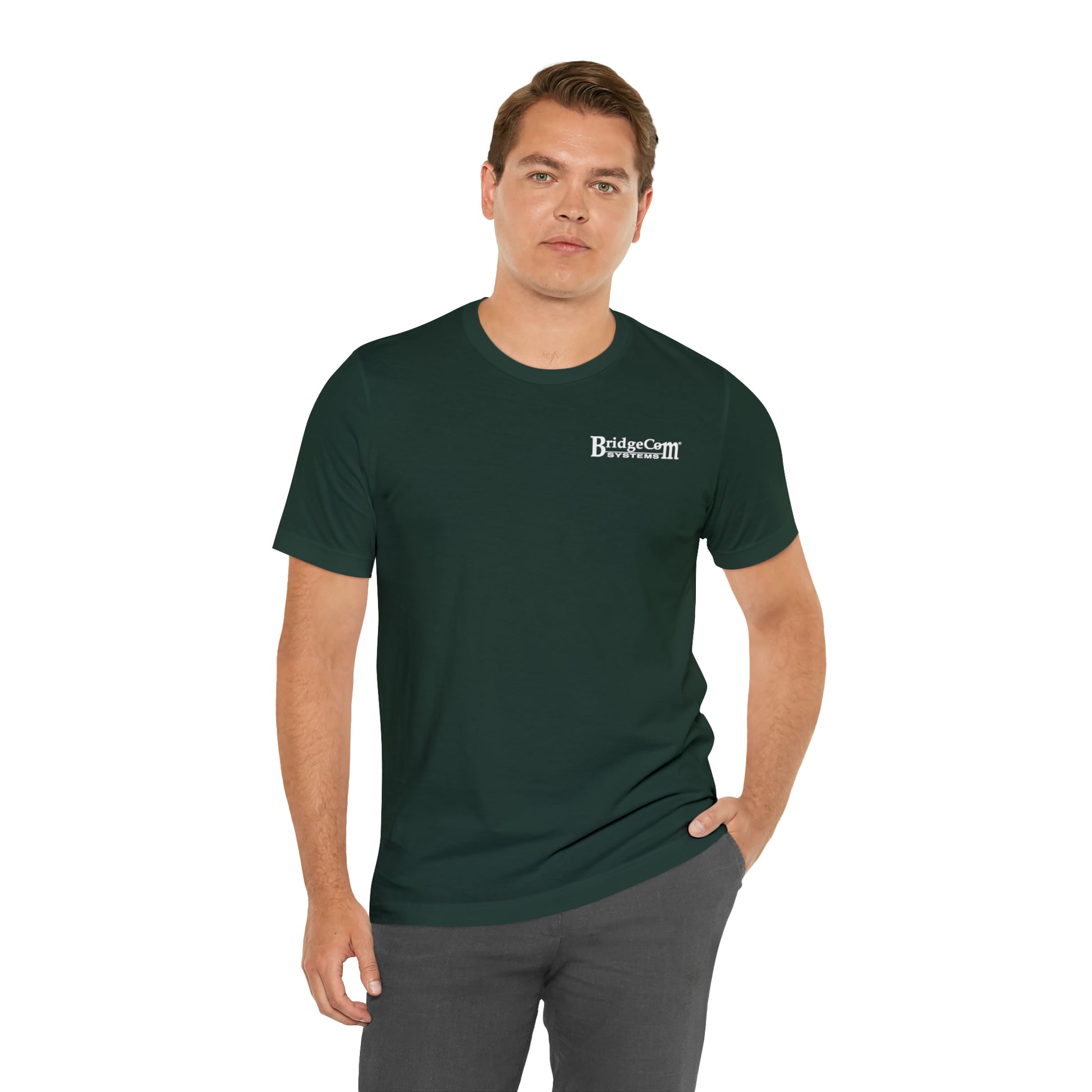 A man stands with one hand in his pocket, wearing the "Short Sleeve Tee - Small Logo" in dark green, made from Airlume cotton with the text "BridgeCiti Properties" on the left chest area. He has short hair and is facing the camera against a plain white background.