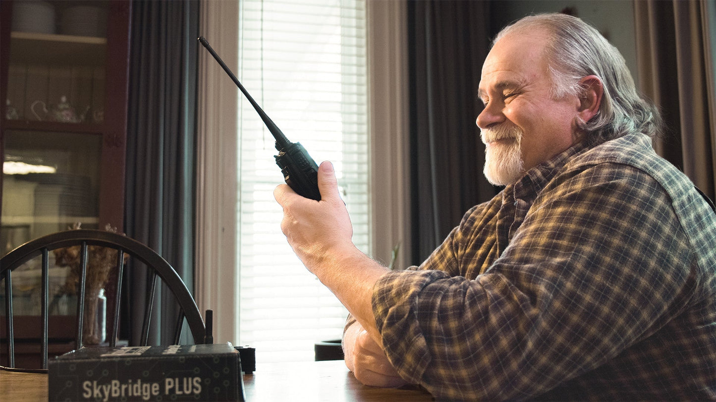 Old man holding 878 radio