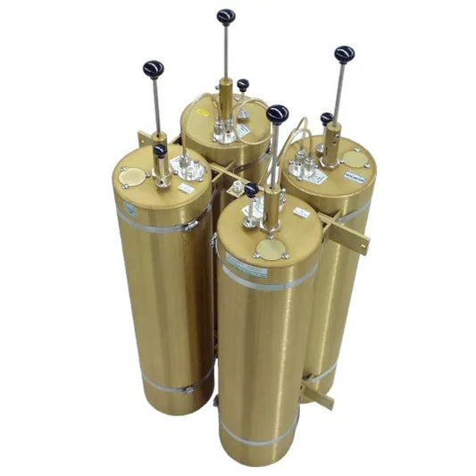 Four TXRX 2m (VHF) 400W Duplexers, which are large cylindrical gold-colored tanks with vertical black handles on top, are arranged closely together in a cluster. These silver-plated duplexers feature several valves and labels on their surfaces, operate within a 144-174 MHz frequency range, and boast a robust 400 W power rating.