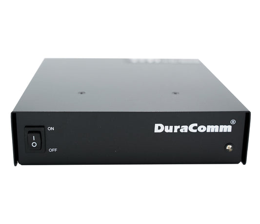 The Duracomm LPX-18BC Power Supply with Built-In Battery Charger is a black rectangular electronic device featuring the brand name "DuraComm" printed in white on the front. It includes a power switch labeled "ON" and "OFF" on the left side, a small LED indicator light on the right, and supports both AC input voltage and DC output voltage.