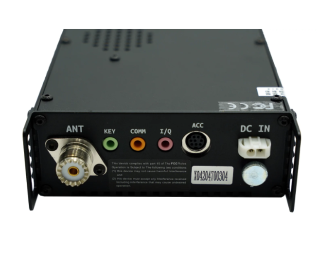 A factory refurbished Xiegu G90, resembling an HF radio, showcases a black electronic design with various ports labeled ANT, KEY, COMM, I/Q, ACC, and DC IN. The serial number is printed on a sticker on its panel, which features multiple input/output connectors against a plain white background.