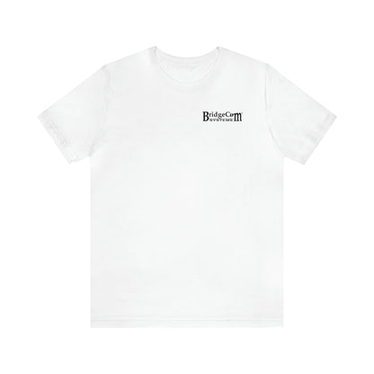 A Short Sleeve Tee - Small Logo made from soft Airlume combed cotton, featuring a small black "BridgeCom Systems" logo on the upper left chest. This plain white shirt has short sleeves and a crew neckline, offering a simple and clean design without any additional graphics or patterns.