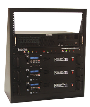 A black rack-mounted repeater control center setup, containing multiple electronic devices, is installed in a sturdy 14-gauge steel Tabletop 12U Rack. The setup features components labeled "BridgeCom Systems," with buttons, indicator lights, and ports neatly arranged on their front panels.