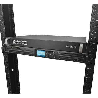 The BridgeCom BCR-GMRS Repeater System with Duplexer is designed for GMRS use, features a digital display and control buttons, and is mounted in a black server rack with numbered slots.
