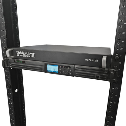 The BridgeCom BCR-GMRS Repeater System with Duplexer is designed for GMRS use, features a digital display and control buttons, and is mounted in a black server rack with numbered slots.