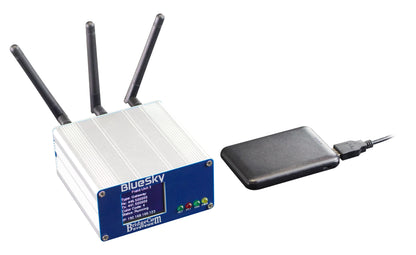 A BridgeCom Bluesky - Amateur Private DMR UHF Network Duplex Hotspot with three antennas and a digital display sits beside a USB-connected black external hard drive, perfect for creating your own private DMR network.