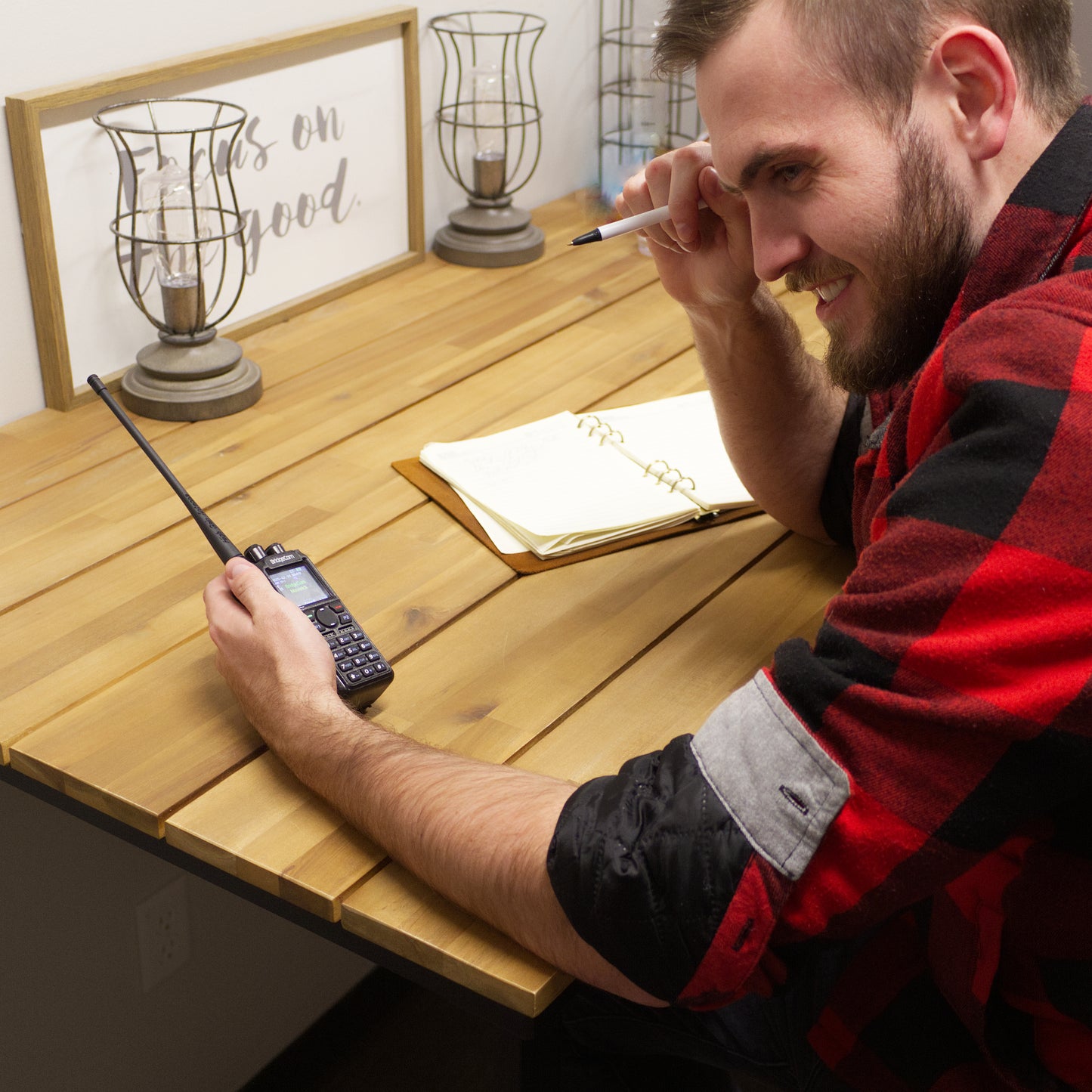 Man enjoying himself using BC Maverick radio while writing in a notebook