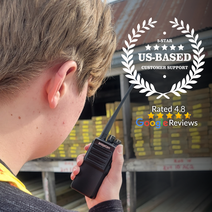 Using a BridgeCom BP-268 UHF 6W Analog/DMR radio, a person stands before stacks of lumber, symbolizing our 5-star US-based customer support. With a Google Reviews rating of 4.8, we offer seamless communication with up to 256 channels and digital encryption.