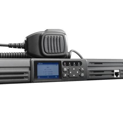 A close-up of the BCR-GMRS Repeater & Duplexer Power Bundle by BridgeCom Systems with a coiled handheld microphone and display screen showing frequency info. This GMRS repeater is FCC Part 95E certified. The background is plain white.