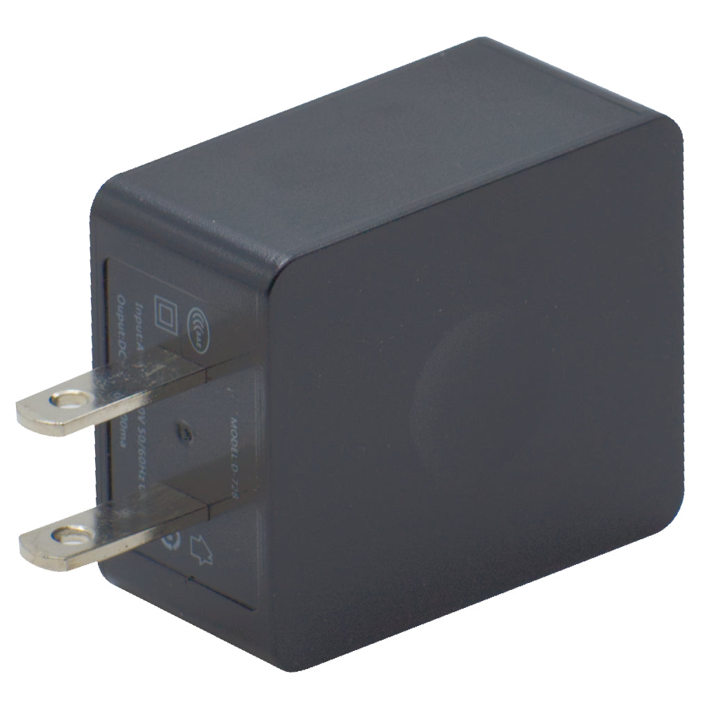 A close-up view of a black wall plug adapter with two metal prongs sitting in the Echo E30 Charger Base w/wall charger. The rectangular adapter features a smooth matte finish, with electrical specifications printed on one side. The slightly angled prongs are designed for standard electrical outlets.