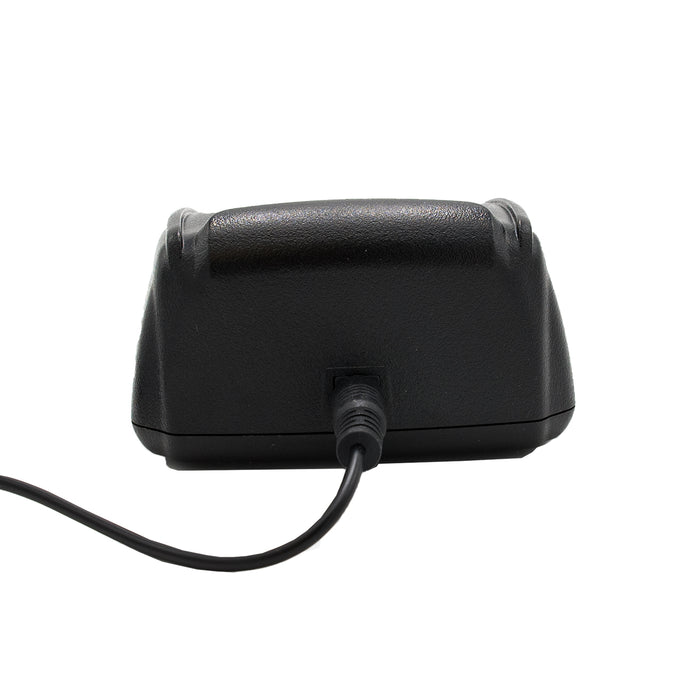 A close-up view of a black AnyTone AT-D868UV / AT-D878UV Charging Base Kit, connected to a power cable. The device has a textured casing and is photographed against a white background.
