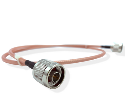 Image of a 3-foot RG142 N-Male to N-Male Jumper Cable with two connectors. One connector features a larger, metallic, threaded surface and is in the foreground facing the viewer, while the other, smaller connector is in the background. The vividly pink-colored cable stands out against a neutral backdrop.