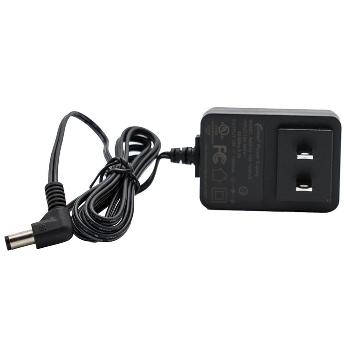 An image of a black electrical power adapter, part of the AnyTone AT-D868UV / AT-D878UV Charging Base Kit, featuring a two-prong plug and a long, coiled cable ending in a cylindrical connector. Text and symbols indicating power specifications are printed on the adapter body.