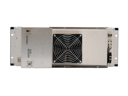 The Crescend 5-10W input 100W output UHF power amplifier, operating within the 403-450 MHz range, is a metallic rectangular device featuring various ports and connections labeled "Antenna" and "Receiver" on the left side. It has a centrally located cooling fan covered by a protective grille, indicating it to be an advanced electronic receiver unit with a 100 W output power capability.