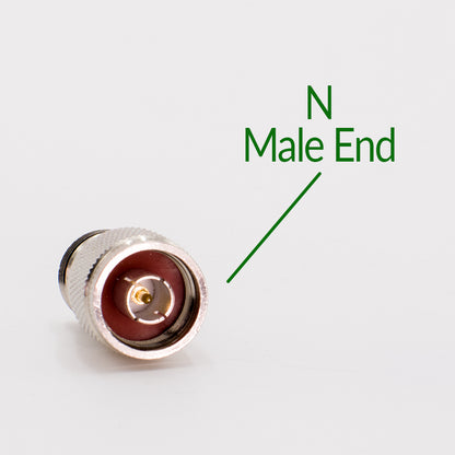 Close-up image of an N male to UHF female adapter with a metal exterior and an internal pin visible at the center. The connector is placed on a plain white background, and a label pointing to it reads "N Male End". This high-quality component can be paired with various coax adapters.